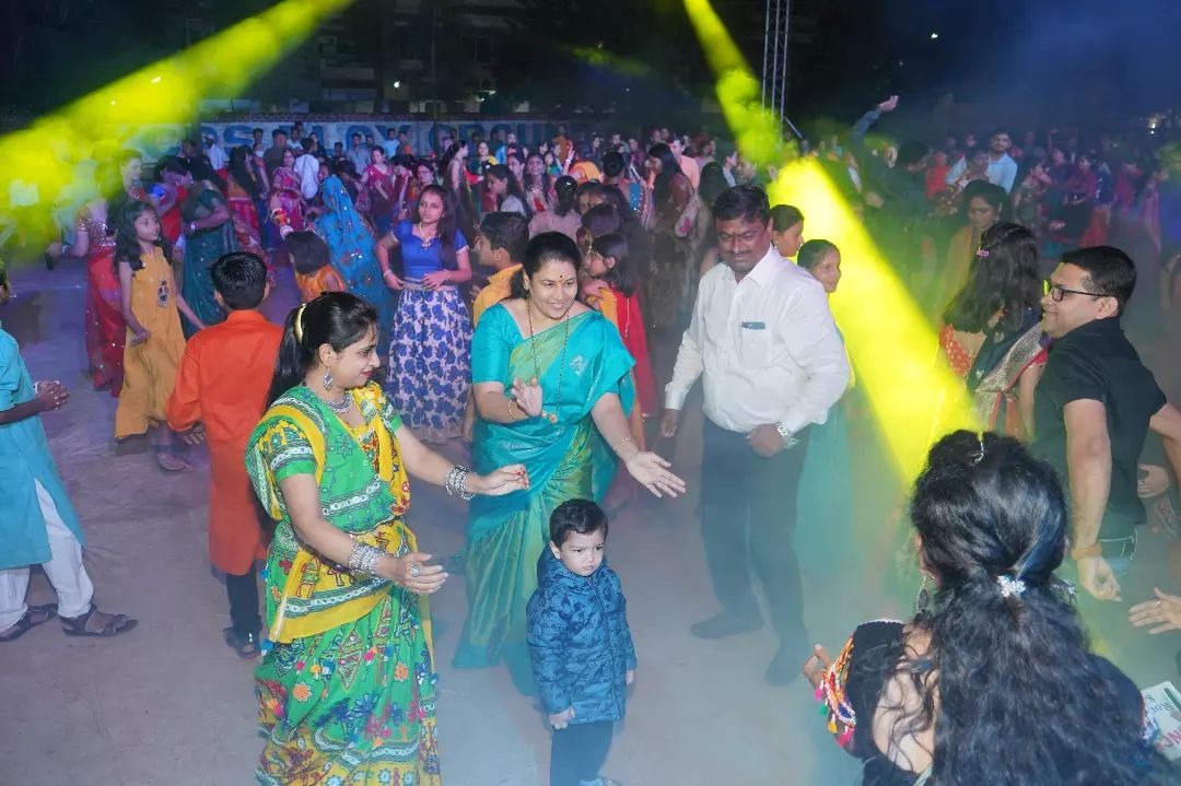 Group standing under a wooden structure