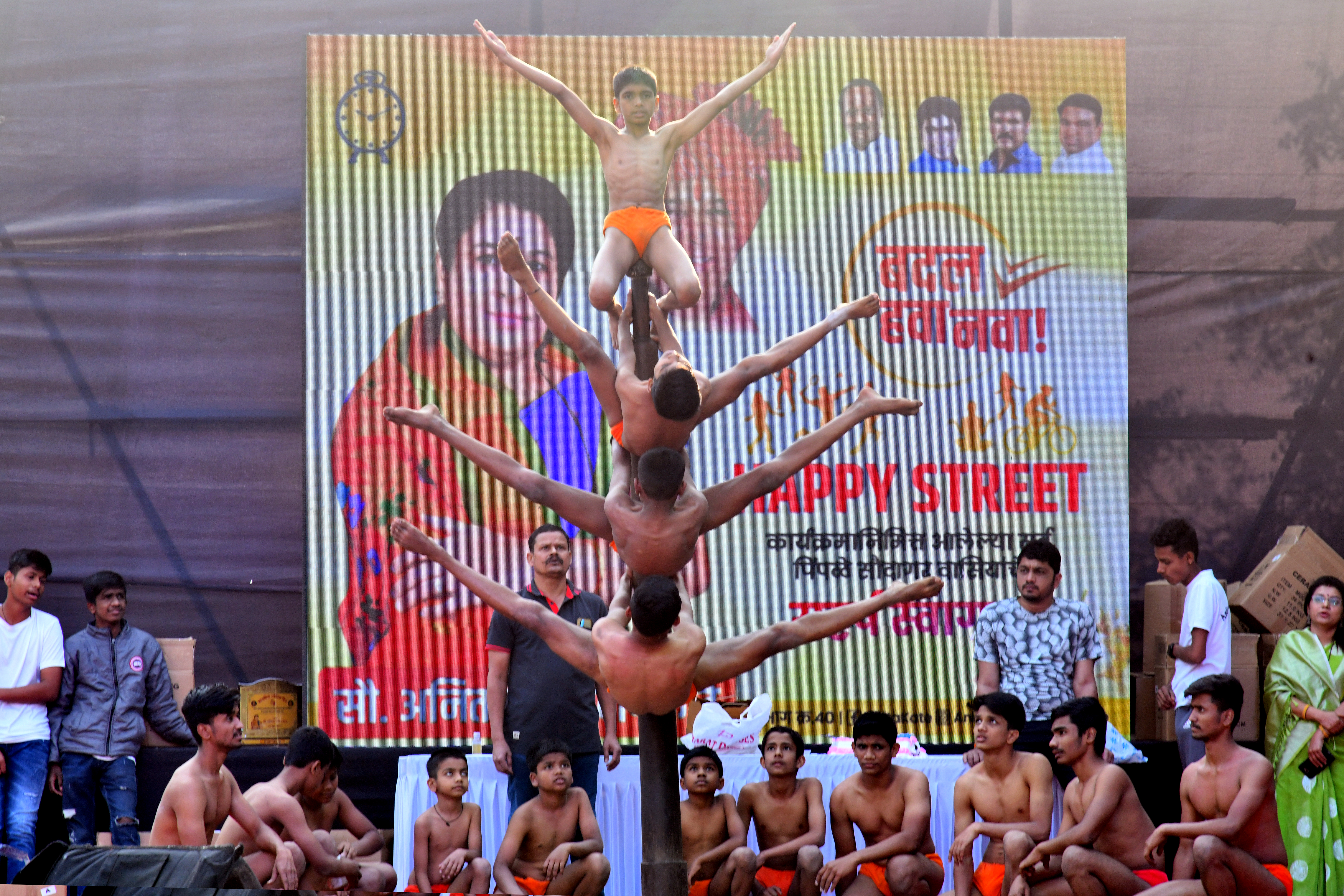 Group standing under a wooden structure